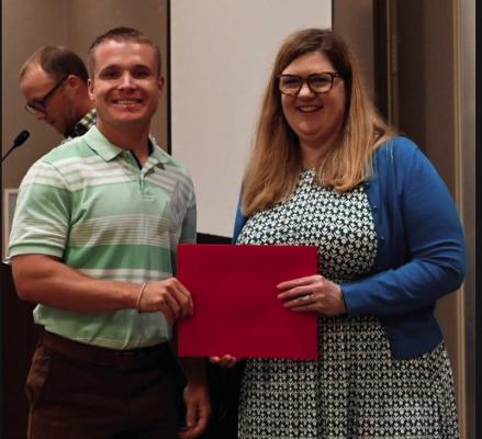 Malachi Newton (left), SWOSU Biological and Biomedical Sciences student, received the Outstanding Poster Award from Dr. Sara Vesely, Director of Undergraduate Research at the SURP Symposium. Courtesy photo